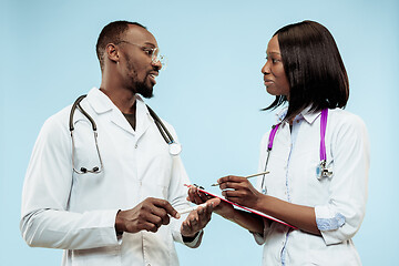 Image showing The female and male f happy afro american doctors on blue background