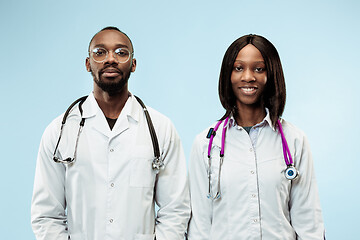 Image showing The female and male f happy afro american doctors on blue background