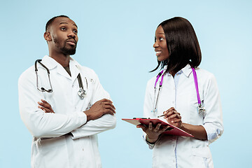 Image showing The female and male f happy afro american doctors on blue background