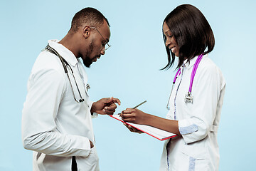 Image showing The female and male f happy afro american doctors on blue background