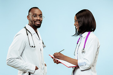 Image showing The female and male f happy afro american doctors on blue background