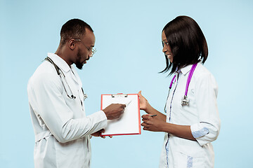 Image showing The female and male f happy afro american doctors on blue background