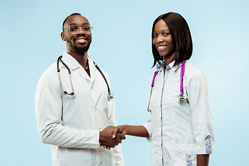 Image showing The female and male f happy afro american doctors on blue background