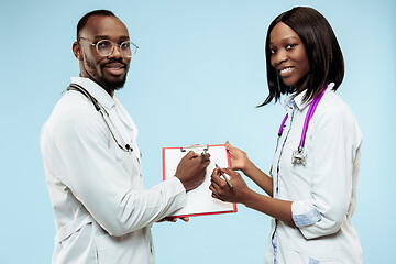 Image showing The female and male f happy afro american doctors on blue background