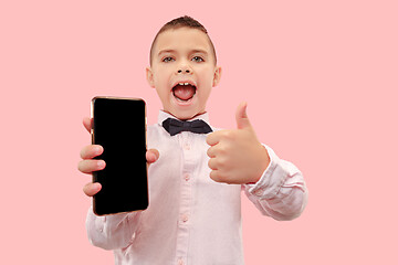 Image showing Indoor portrait of attractive young boy holding blank smartphone