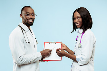 Image showing The female and male f happy afro american doctors on blue background