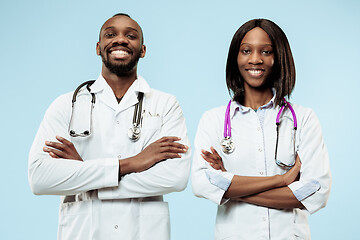 Image showing The female and male f happy afro american doctors on blue background