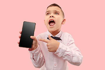 Image showing Indoor portrait of attractive young boy holding blank smartphone