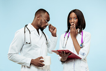 Image showing The female and male happy afro american doctors on blue background