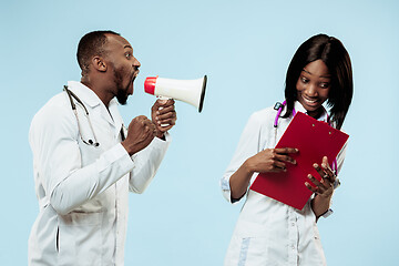 Image showing The female and male happy afro american doctors on blue background