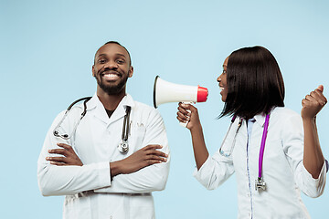 Image showing The female and male happy afro american doctors on blue background