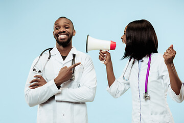 Image showing The female and male happy afro american doctors on blue background