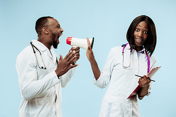 Image showing The female and male happy afro american doctors on blue background