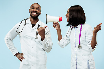 Image showing The female and male happy afro american doctors on blue background