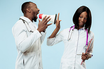 Image showing The female and male happy afro american doctors on blue background