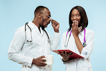 Image showing The female and male happy afro american doctors on blue background