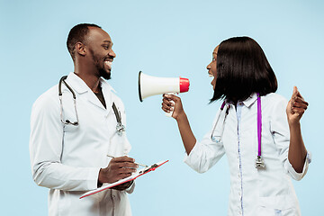 Image showing The female and male happy afro american doctors on blue background