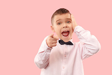 Image showing The young attractive teen boy looking suprised isolated on pink