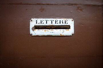 Image showing typical mailbox in a wooden door in Italy