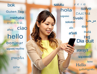 Image showing happy asian woman using smartphone