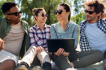 Image showing friends with tablet pc computer outdoors in summer