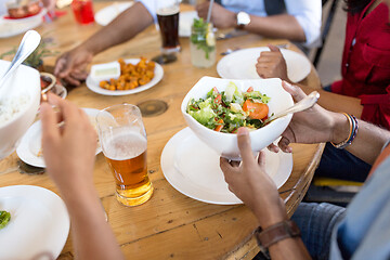 Image showing international friends eating at restaurant