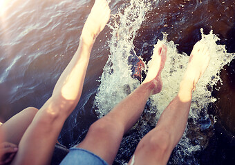 Image showing legs of couple splashing water in river