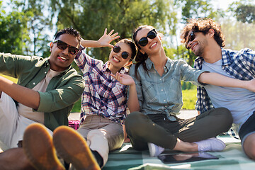 Image showing happy friends taking selfie outdoors in summer