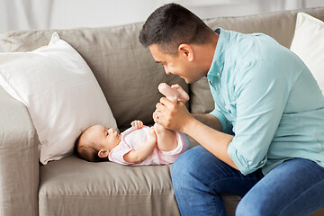 Image showing middle aged father playing with baby at home