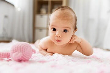 Image showing sweet baby girl lying on knitted plush blanket