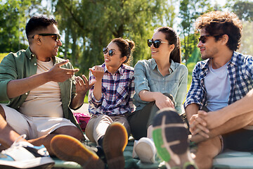 Image showing friends hanging out and talking outdoors in summer