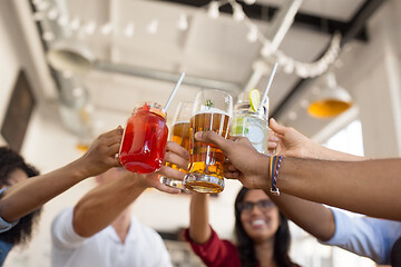 Image showing friends clinking glasses at bar or restaurant