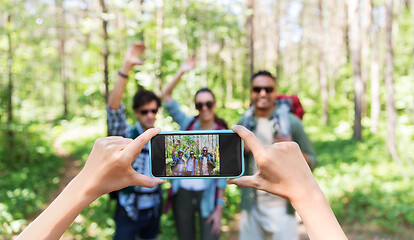 Image showing friends with backpacks being photographed on hike