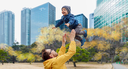 Image showing father with son having fun in autumn tokyo city