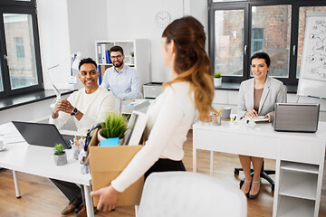 Image showing happy businesswoman with personal stuff at office