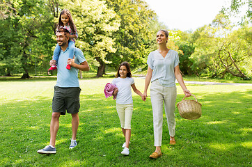 Image showing family with picnic basket walking in summer park