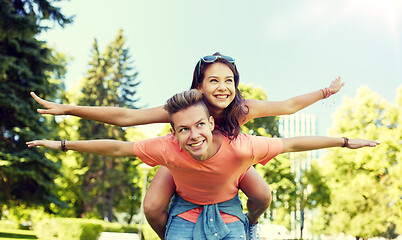 Image showing happy teenage couple having fun at summer park