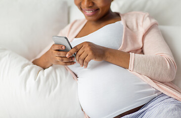 Image showing pregnant woman with smartphone in bed at home