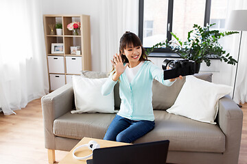 Image showing asian female blogger with camera recording video