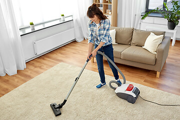 Image showing asian woman with vacuum cleaner at home