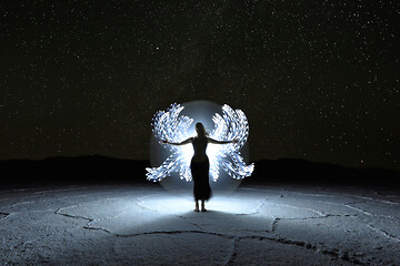 Image showing Light Painted Long Exposure Image of a Woman with the Milky Way