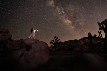 Image showing Girl Holding Lantern in the Desert Under the Milky Way