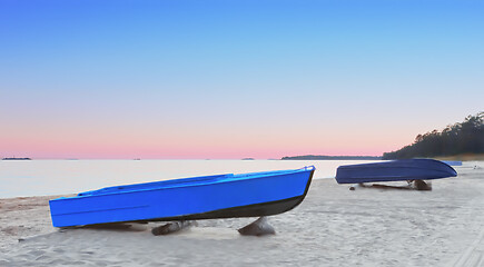 Image showing Fishing Boats On The Beach At Pink Sunset