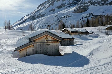 Image showing aerial snow covered mountain peaks in alps at winter 