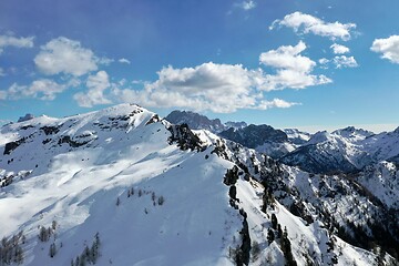 Image showing aerial snow covered mountain peaks in alps at winter 