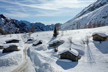 Image showing aerial snow covered mountain peaks in alps at winter 