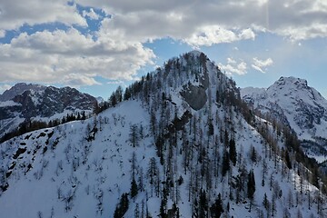 Image showing aerial snow covered mountain peaks in alps at winter 