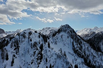 Image showing aerial snow covered mountain peaks in alps at winter 