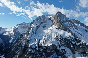 Image showing aerial snow covered mountain peaks in alps at winter 