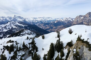 Image showing aerial snow covered mountain peaks in alps at winter 